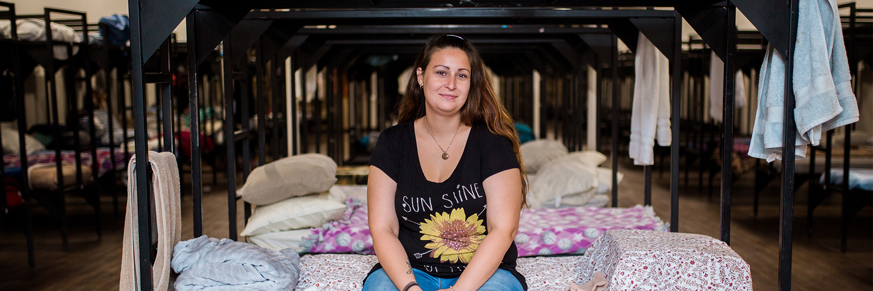 Woman sitting on a bed